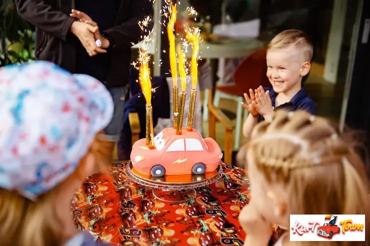 joyful scene of six-year-old children gathered around a birthday cake inside.