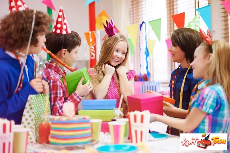 A blonde girl wearing a crown at her birthday party, surrounded by friends.