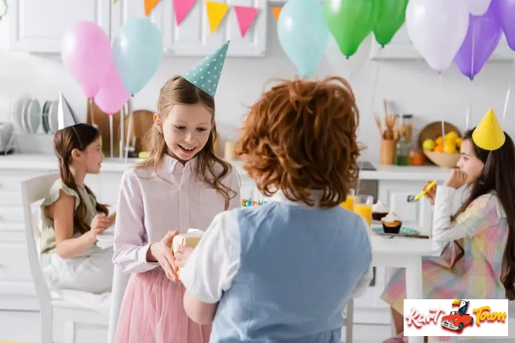 Girl receiving gift at a colorful home birthday party
