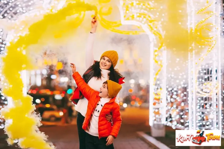 Family celebrating with festive lights and smoke.