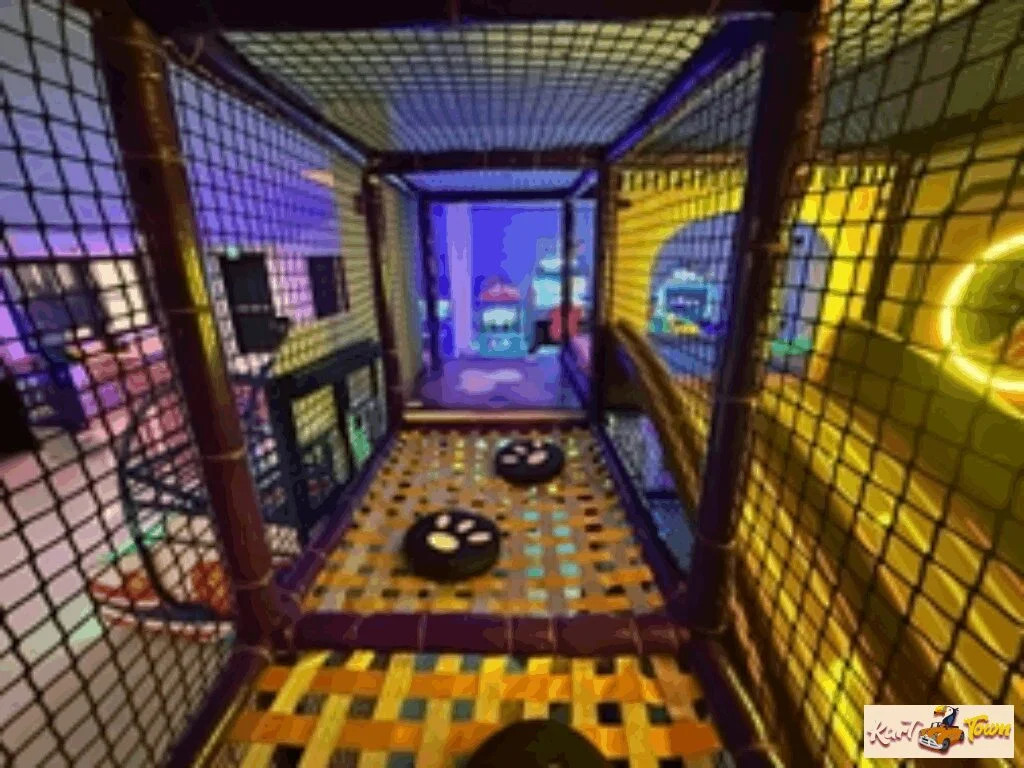 Netted play tunnel with black paw-print stepping pads on a yellow patterned floor and colorful cartoon panels at the far end.
