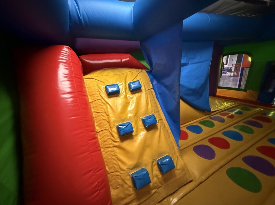 Inflatable bouncy castle with climbing wall and slide at Kart Town