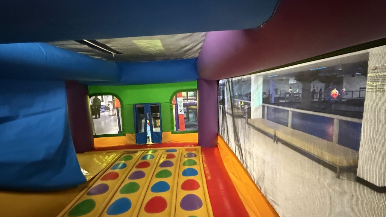 Bouncy castle interior with spotted floor and slide ramp