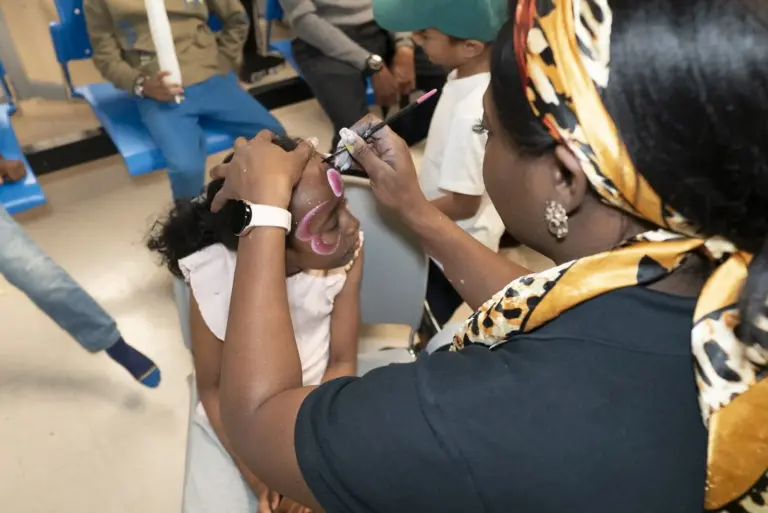Child getting their face painted at the anniversary event