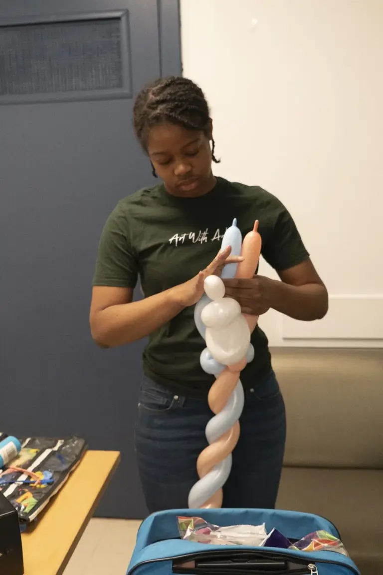 Balloon artist twisting balloons at the event