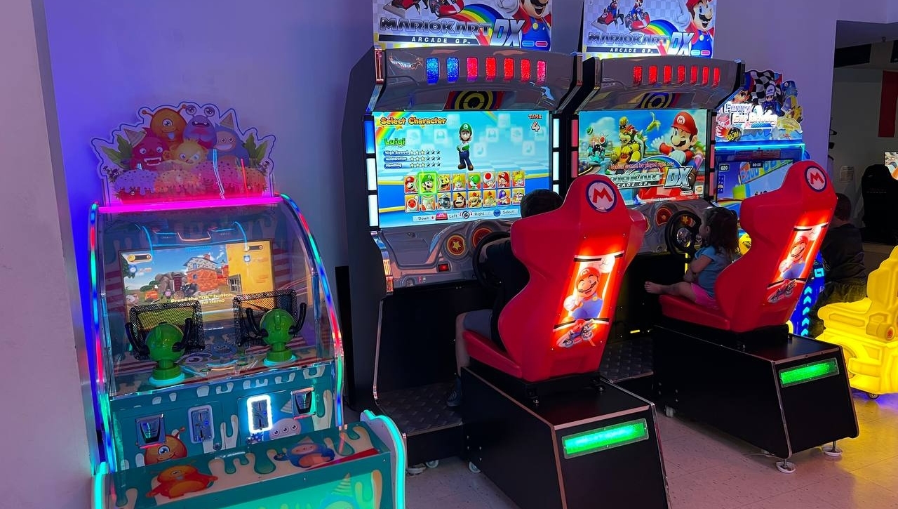 Arcade with Mario Kart DX racing cabinets and monster-themed kiddie games