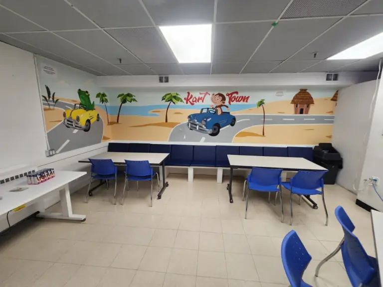 Monkey Room birthday party space with palm tree beach mural and monkey driving a car at Kart Town