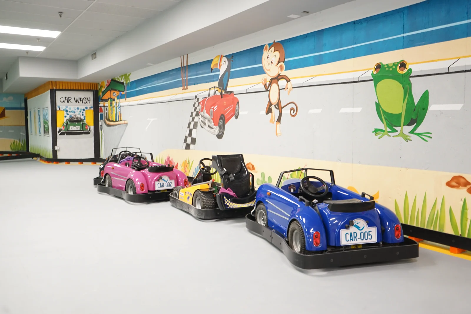 Classic Karts parked beside the mural at Kart Town