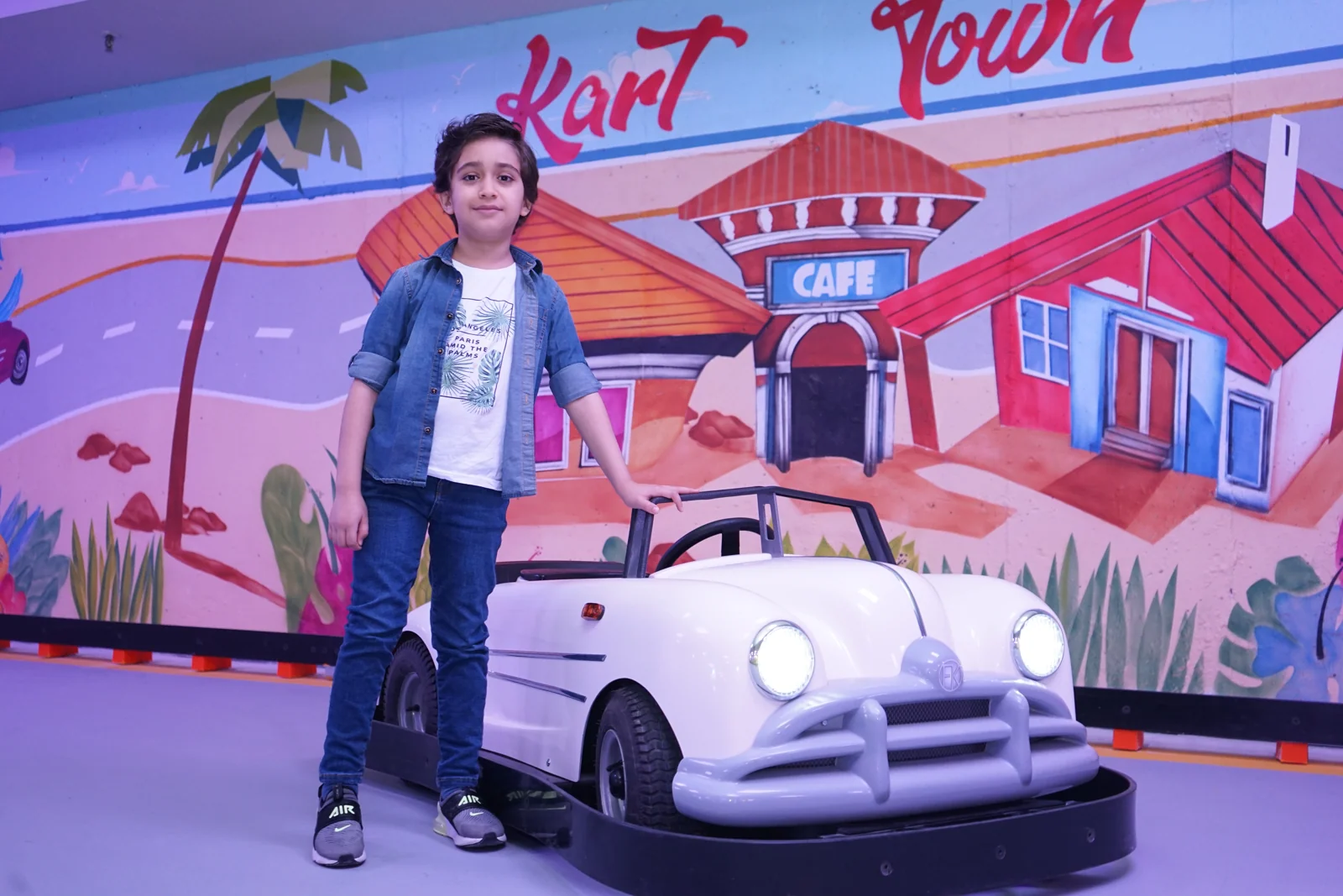 Child beside a Classic Kart at Kart Town