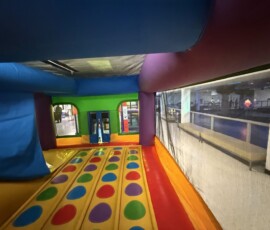Tons of room to jump and play inside the bouncy castle. Bouncy castle interior with spotted floor and slide ramp