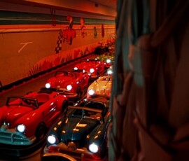 Cruise our fleet of retro classic cars along a fun, themed indoor course. Lineup of retro classic cars with headlights on at Kart Town
