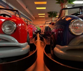 Take a gentle, nostalgic spin in our beautifully detailed classic cars. Close-up of two vintage-style classic ride cars