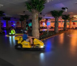 Feel the speed — our go-karts zip around the track for an exciting ride. Go-kart speeding around the indoor track