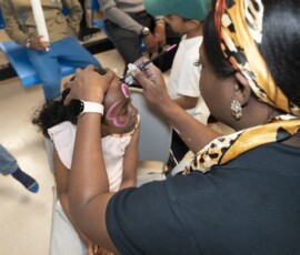 Vibrant face painting was a highlight of the celebration. Child getting their face painted at the anniversary event
