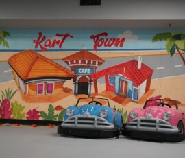 Our bright beach-diner mural makes the perfect backdrop for a race. Pink and blue go-karts beside the bright Kart Town beach diner mural